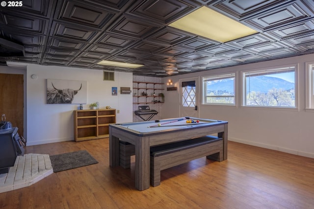 recreation room with baseboards, an ornate ceiling, visible vents, and light wood finished floors