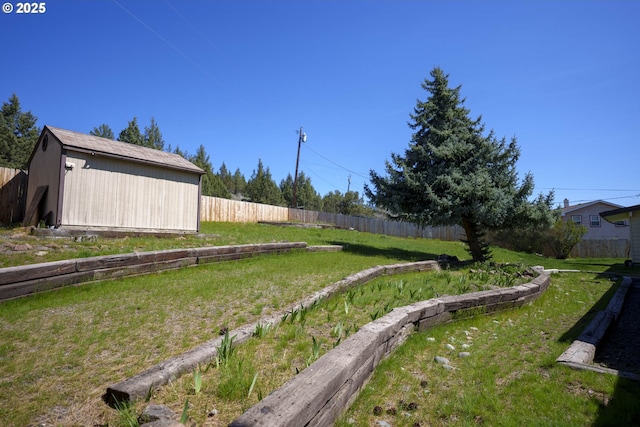 view of yard with fence, an outbuilding, and a shed