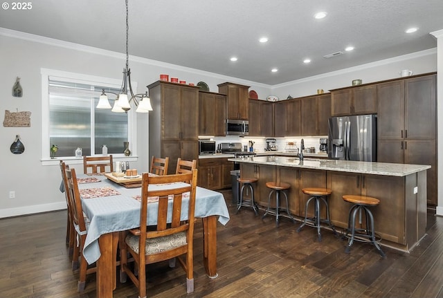 16949 SW Appledale Rd, Beaverton, OR 97007 - kitchen featuring stainless steel appliances, crown molding, recessed lighting, an island with sink, and dark wood-style flooring