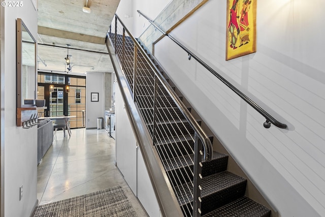 stairway with concrete flooring