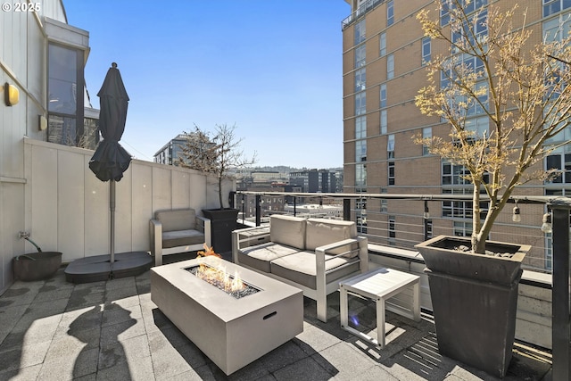 view of patio / terrace with an outdoor living space with a fire pit