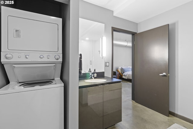 laundry room featuring sink and stacked washing maching and dryer