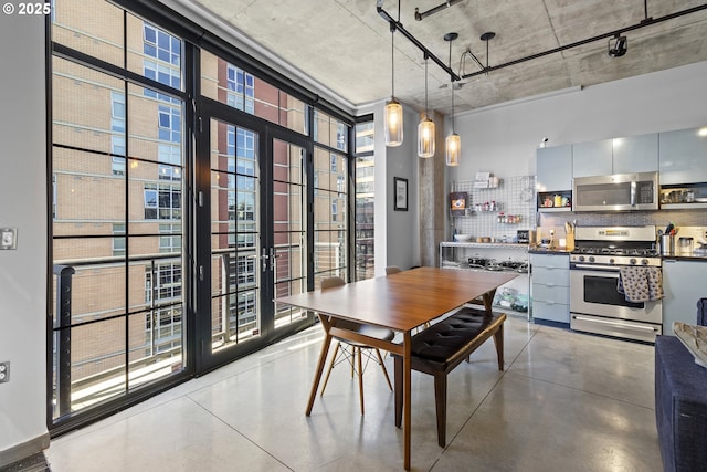 dining area with expansive windows and concrete floors