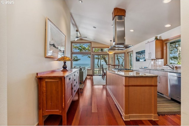 kitchen with a sink, a center island, stainless steel appliances, island range hood, and vaulted ceiling