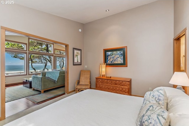 bedroom with baseboards and a water view