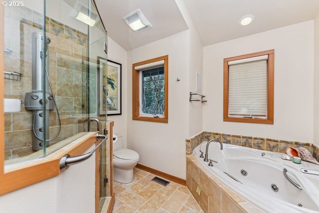 bathroom featuring a shower stall, a tub with jets, and visible vents