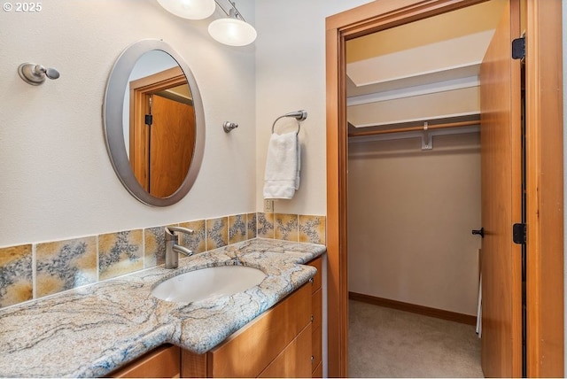 bathroom with vanity and baseboards