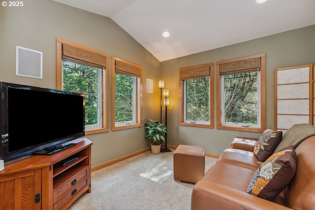 living area featuring baseboards, lofted ceiling, and light colored carpet