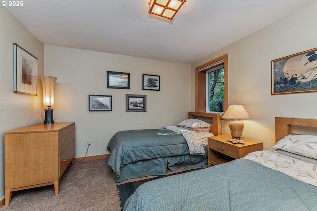 bedroom with baseboards and light colored carpet