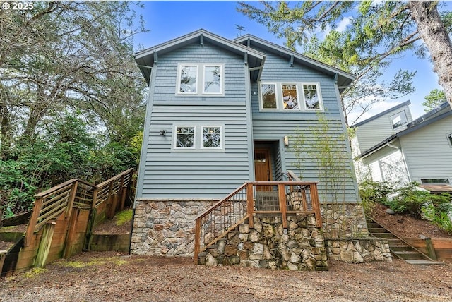 back of house with stone siding