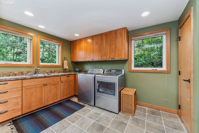 laundry room featuring plenty of natural light, cabinet space, independent washer and dryer, and a sink