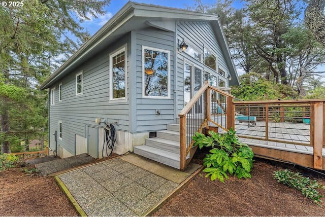 rear view of property featuring a deck