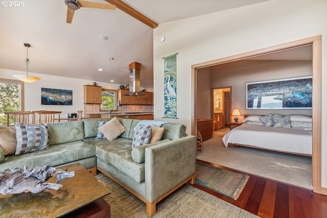 living room featuring lofted ceiling with beams, wood finished floors, and recessed lighting