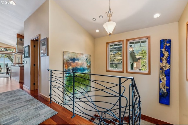 stairs with vaulted ceiling, recessed lighting, baseboards, and wood finished floors