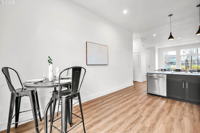 dining area with sink and light hardwood / wood-style flooring