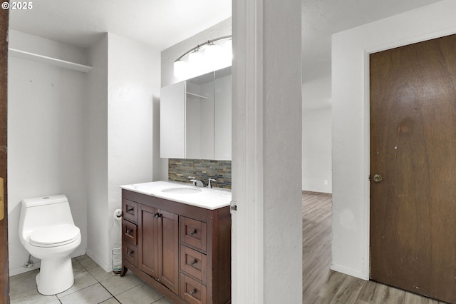 4021 N Clarey St, Eugene, OR 97402 - bathroom featuring toilet, vanity, decorative backsplash, and tile patterned flooring