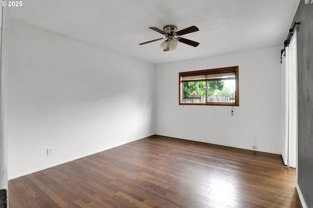 4021 N Clarey St, Eugene, OR 97402 - spare room with a barn door, a ceiling fan, and dark wood-style flooring