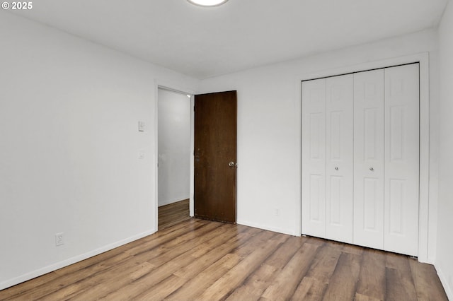 4021 N Clarey St, Eugene, OR 97402 - unfurnished bedroom with wood finished floors, a closet, and baseboards