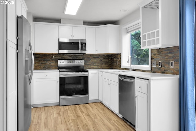 4021 N Clarey St, Eugene, OR 97402 - kitchen featuring appliances with stainless steel finishes, white cabinets, decorative backsplash, and a sink