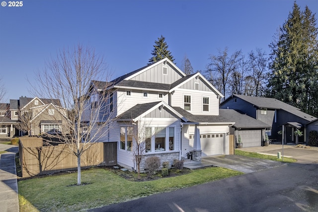 view of front of property featuring a garage and a front yard