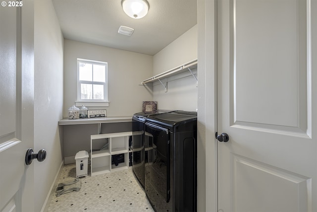 clothes washing area featuring washer and clothes dryer