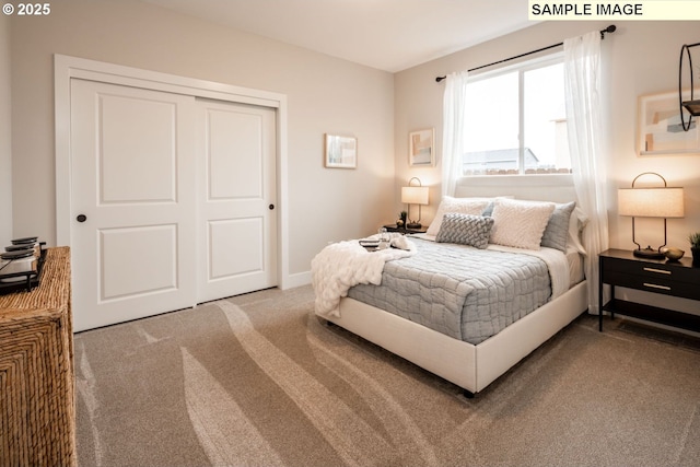 carpeted bedroom featuring a closet and baseboards