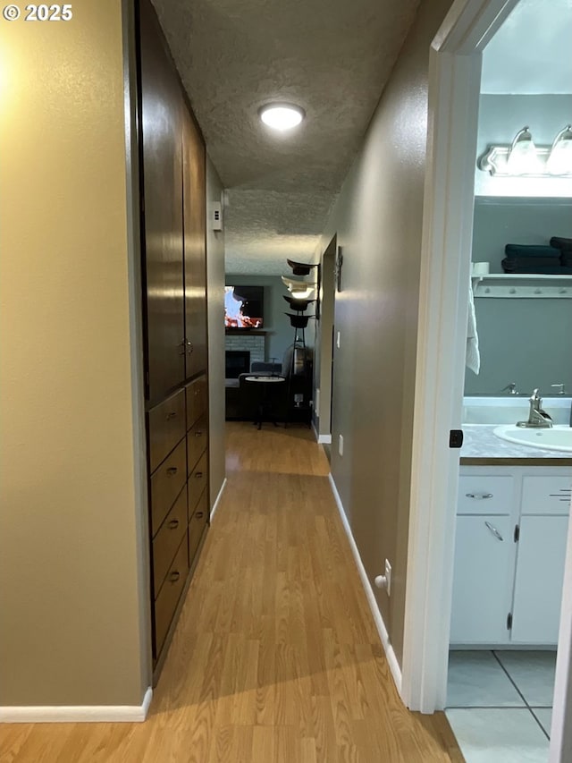 1082 Dondea St, Springfield, OR 97478 - corridor featuring a sink and light wood-style flooring