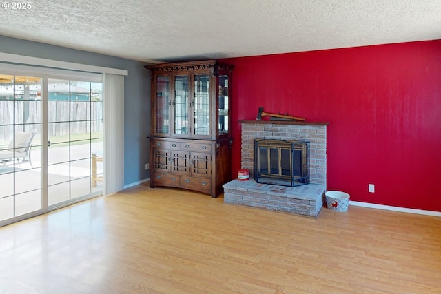 1082 Dondea St, Springfield, OR 97478 - unfurnished living room featuring a textured ceiling, wood finished floors, and a fireplace