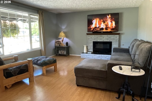 1082 Dondea St, Springfield, OR 97478 - living area with a textured ceiling, wood finished floors, and a fireplace