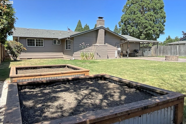 1082 Dondea St, Springfield, OR 97478 - back of property with an outdoor fire pit, a fenced backyard, a patio area, and a chimney
