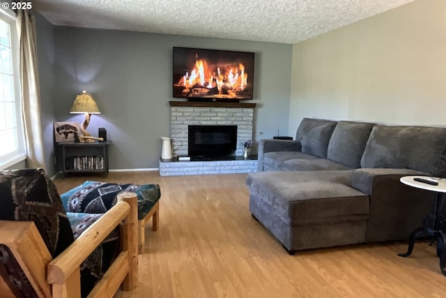 1082 Dondea St, Springfield, OR 97478 - living area featuring a textured ceiling, wood finished floors, and a brick fireplace