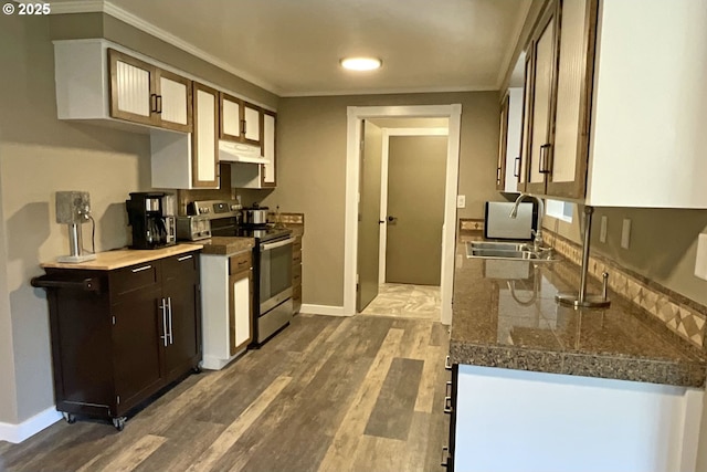1082 Dondea St, Springfield, OR 97478 - kitchen with stainless steel electric stove, under cabinet range hood, ornamental molding, wood finished floors, and tile countertops