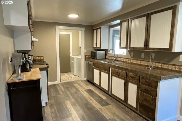 1082 Dondea St, Springfield, OR 97478 - kitchen with washing machine and clothes dryer, appliances with stainless steel finishes, wood finished floors, dark countertops, and extractor fan