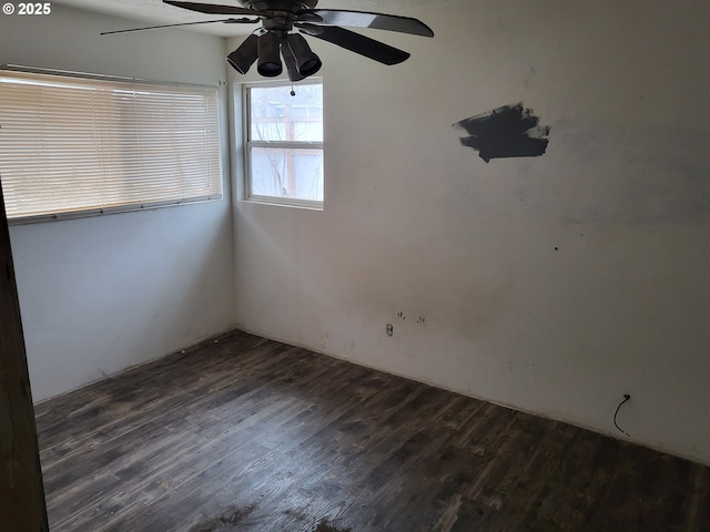 unfurnished room featuring a ceiling fan and dark wood-style flooring