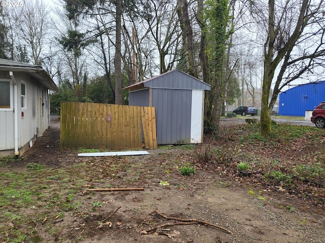 view of yard with a storage shed and an outbuilding