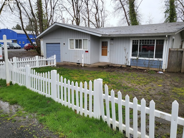 ranch-style home featuring a fenced front yard and board and batten siding