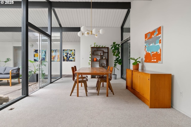 dining room with light colored carpet, beam ceiling, a chandelier, and high vaulted ceiling