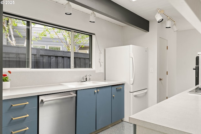 kitchen featuring blue cabinets, dishwasher, freestanding refrigerator, and light countertops