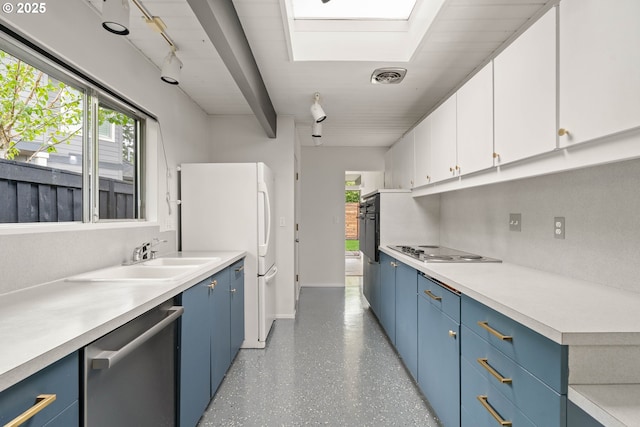 kitchen featuring a sink, electric cooktop, light countertops, dishwasher, and blue cabinetry