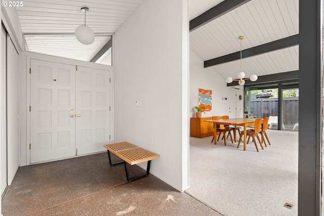 foyer featuring baseboards, lofted ceiling with beams, and speckled floor