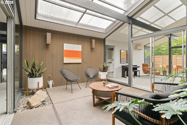 sunroom / solarium featuring a skylight and a wall mounted AC