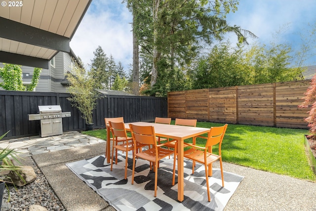 view of patio / terrace with a fenced backyard, grilling area, and outdoor dining space