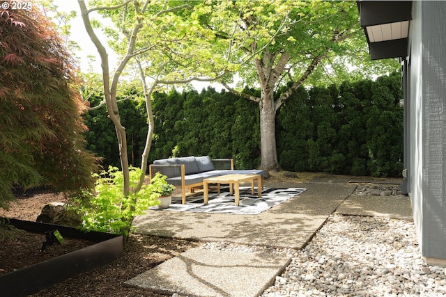 view of patio with a view of trees and outdoor lounge area