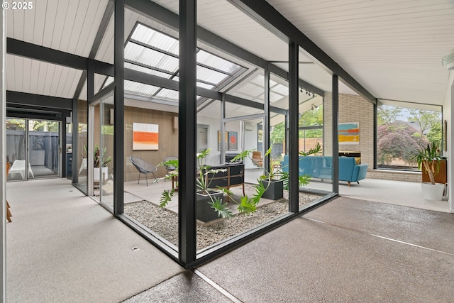 sunroom with plenty of natural light, an outdoor living space, and a skylight