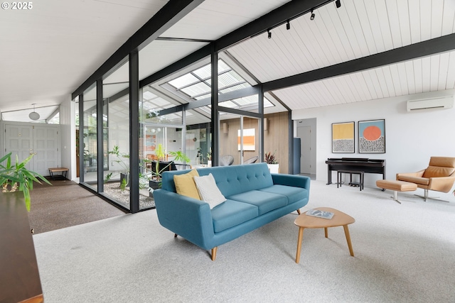 living room featuring carpet flooring, a wall mounted air conditioner, rail lighting, beamed ceiling, and expansive windows