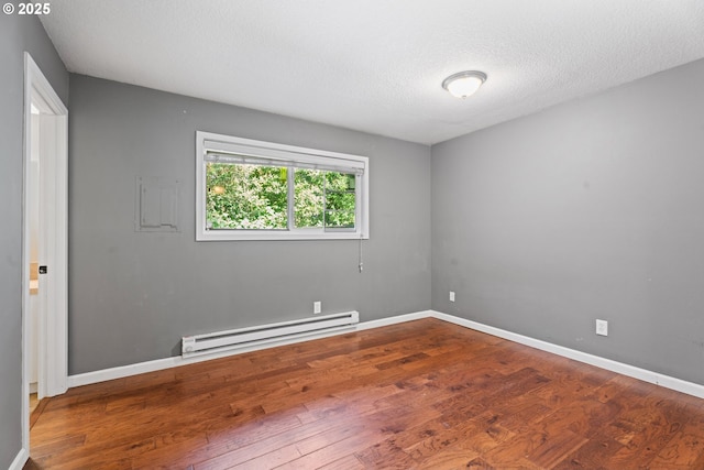 11255 SW Springwood Dr, Portland, OR 97223 - spare room with a baseboard heating unit, wood finished floors, and a textured ceiling