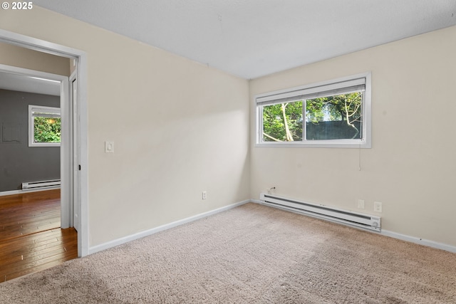 11255 SW Springwood Dr, Portland, OR 97223 - carpeted spare room featuring a baseboard radiator, plenty of natural light, and wood finished floors