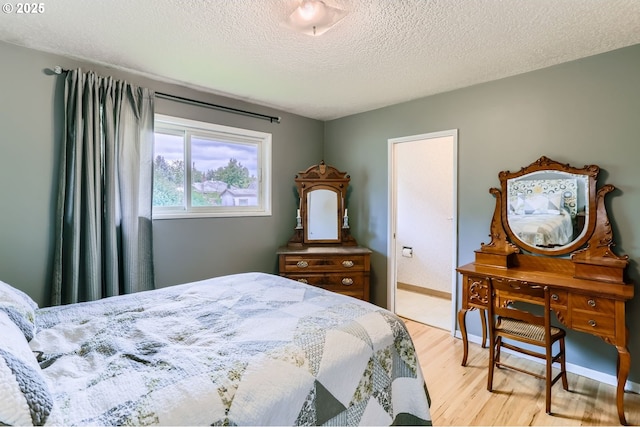 157 NE 11th Dr, Hillsboro, OR 97124 - bedroom with light wood-type flooring and a textured ceiling