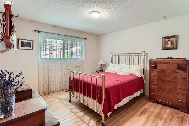 157 NE 11th Dr, Hillsboro, OR 97124 - bedroom with wood finished floors and a textured ceiling