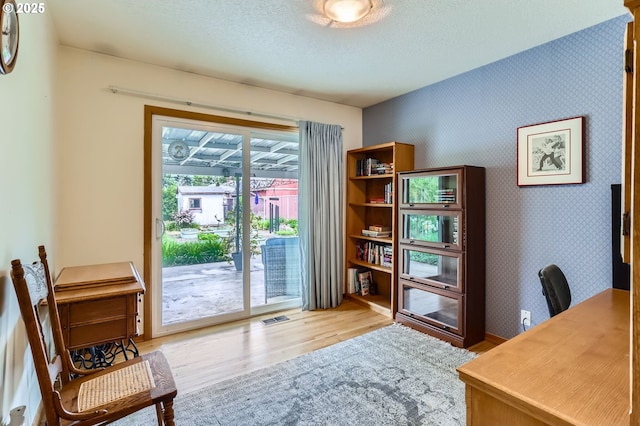 157 NE 11th Dr, Hillsboro, OR 97124 - office area with wood finished floors, a textured ceiling, and wallpapered walls